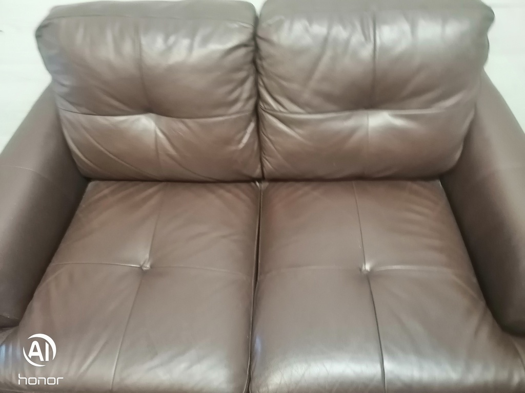 Neat two seater brown leather sofa