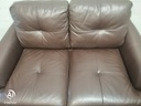 Neat two seater brown leather sofa