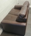 Neat two seater brown leather sofa