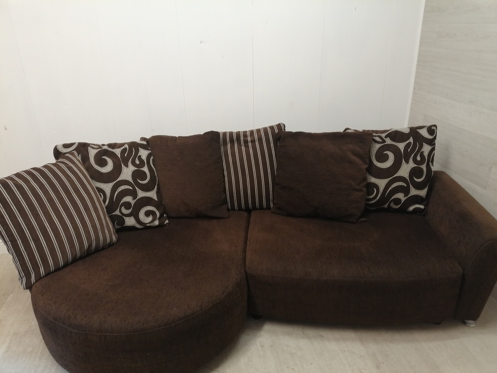 brown toned corner pillow back sofa