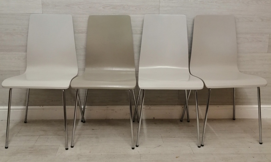 set of four different shades of grey dining chairs