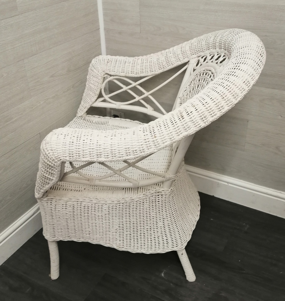 lovely cushioned white wicker armchair