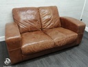 distressed tan leather three seater sofa