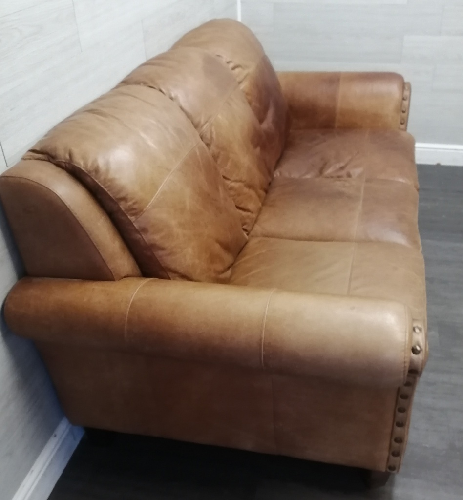 distressed tan leather three seater sofa