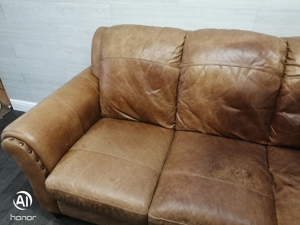 distressed tan leather three seater sofa