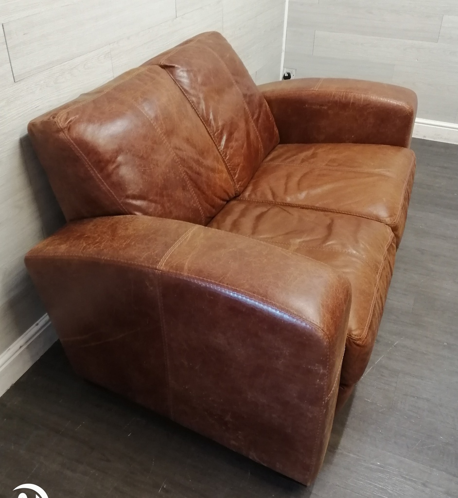 distressed tan leather two seater sofa