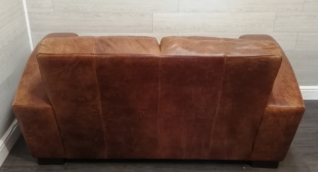 distressed tan leather two seater sofa