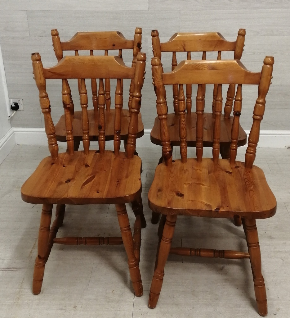 set of four honey pine dining chairs