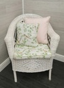 lovely cushioned white wicker armchair